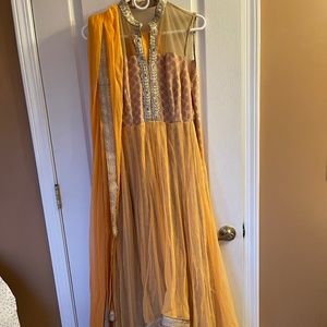 Stunning anarkali in mango orange net and gold/ivory brocade.